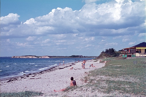 Svino peninsula, Denmark, 1970. Bathers and families on the shallow beach of Svino, Baltic Sea, Also: Cafe house.