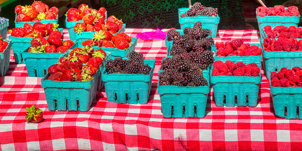 cartons of farmer's market strawberries blackberries and raspberries