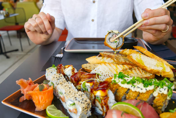 istock eating sushi with chopsticks at sushi restaurant 1328392965