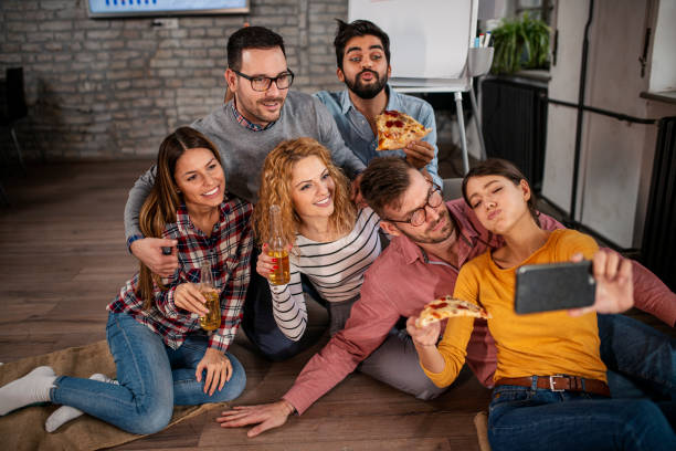 istock Enthusiastic creative business team cheering, taking selfie in office 1328393607