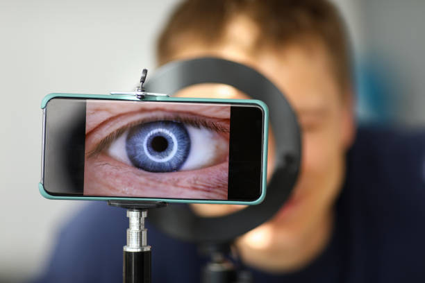 Man making video trying to shoot his own eye using modern smartphone camera
