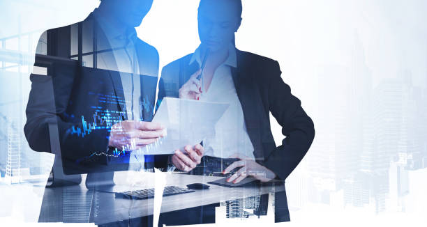 istock Business people with paper report, financial chart on computer screen 1328395248