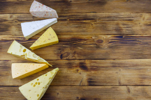 istock Set of various types of cheese on wooden table. Top view, copy space 1328398714