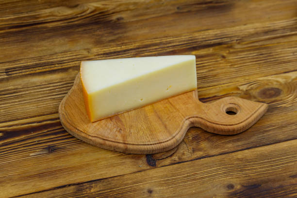 istock Piece of cheese on a wooden table 1328398825