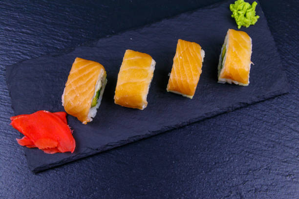istock Sushi rolls Philadelphia on a black slate. Top view 1328398867