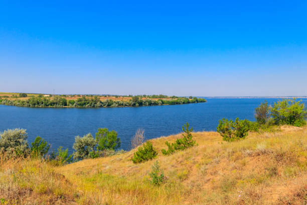 istock Summer landscape with beautiful river, green trees and blue sky 1328399179