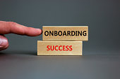 Onboarding success symbol. Wooden blocks with words Onboarding success on beautiful grey background. Businessman hand. Business and onboarding success concept. Copy space.