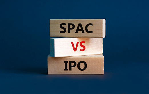 SPAC vs IPO symbol. Blocks with words 'SPAC, special purpose acquisition company' and 'IPO, initial public offering' on grey background, copy space. Business and SPAC vs IPO concept.