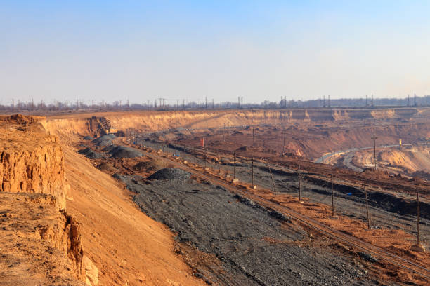 istock Big yellow excavator working in iron ore quarry 1328401339