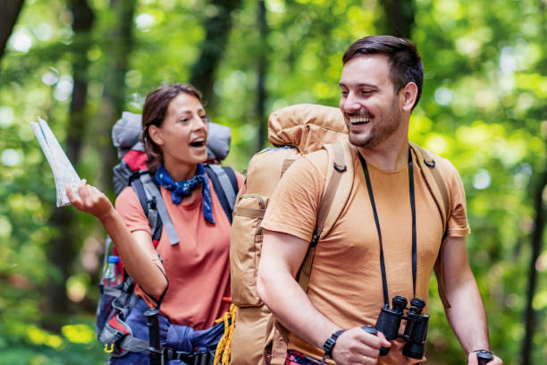 istock Attractive young couple hiking in the forest 1328402841