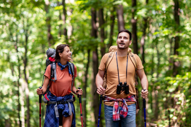 istock Attractive young couple hiking in the forest 1328402874