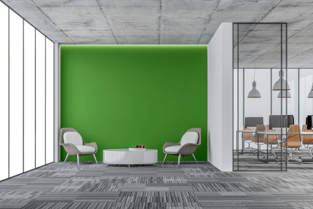 istock Empty office interior: a lounge corner with copy space and wordesks behind glass door 1328404668