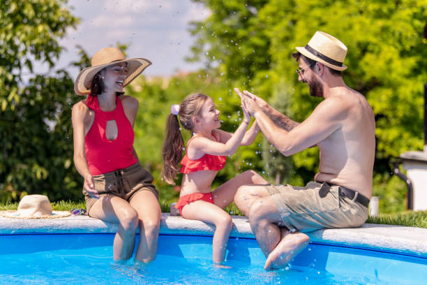 istock Family having fun by swimming pool 1328404727
