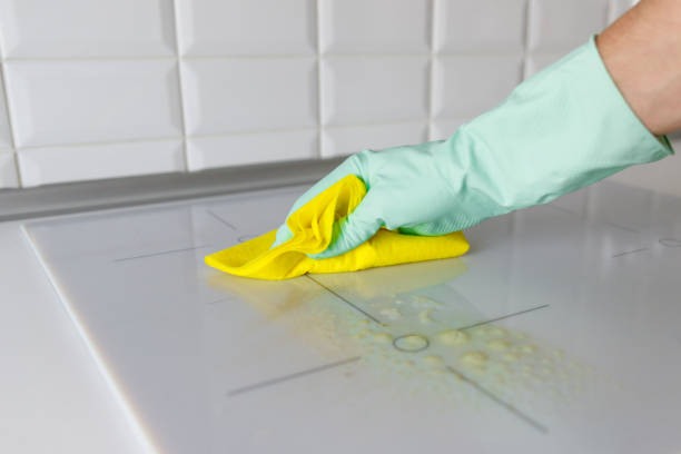 istock man hand in rubber gloves cleaning induction hob 1328405374
