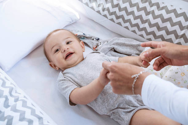 istock Newborn lying in crib looking at camera smiling 1328406288