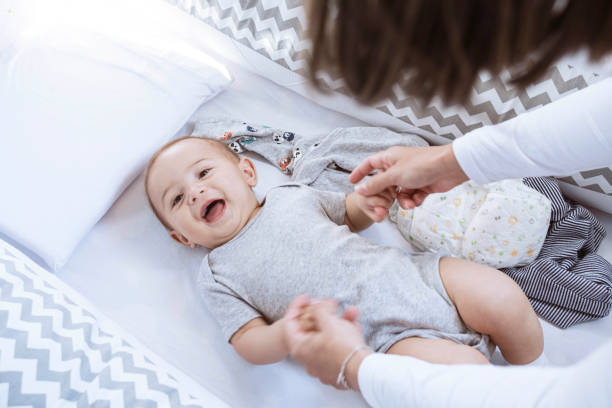 istock Newborn lying in crib looking at camera smiling 1328406333