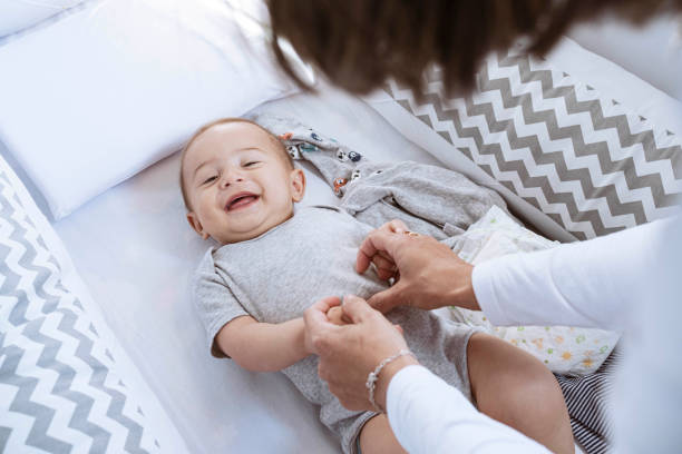 istock Newborn lying in crib looking at camera smiling 1328406361
