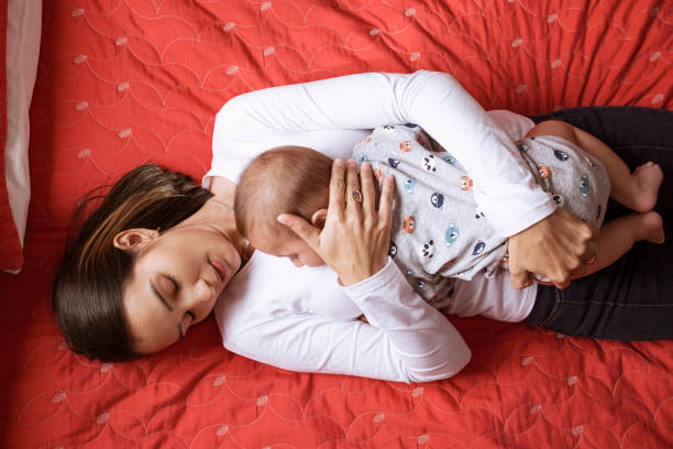 istock Newborn lying on his mother 1328406401