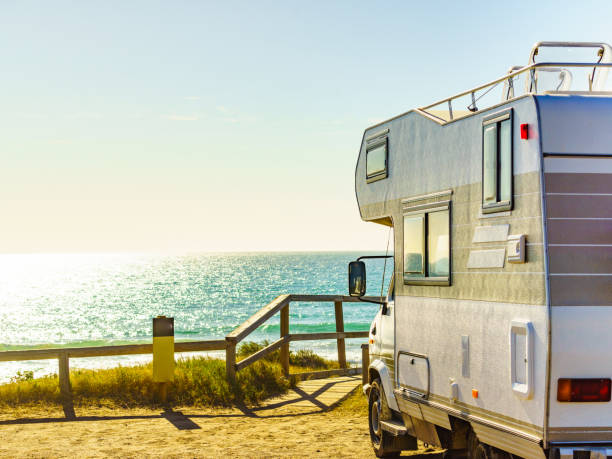 istock Camper rv camping on sea shore, Spain 1328407432