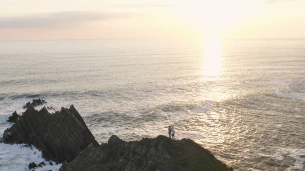 istock Friends hike up rugged coastal mountain peak 1328410176