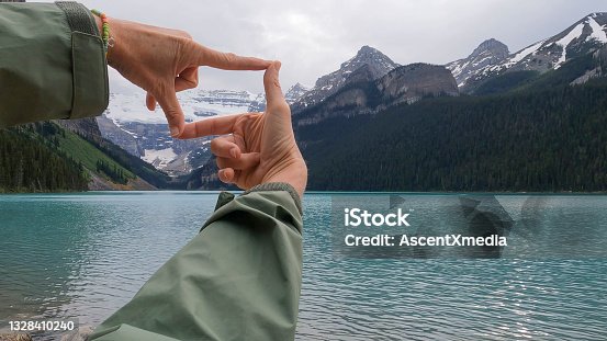 istock Scenic view of woman's hands, conceptually capturing Lake Louise 1328410240