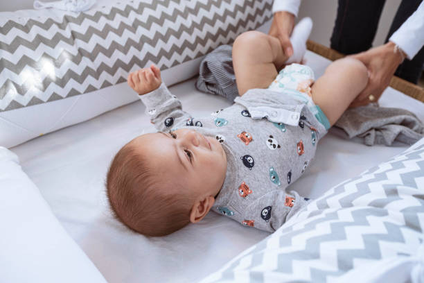 istock Mother diapering her newborn child 1328410359