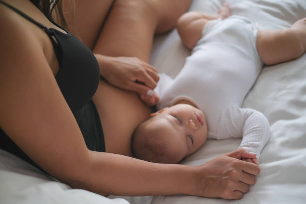 istock Mother Watching Newborn Baby Sleep 1328411020