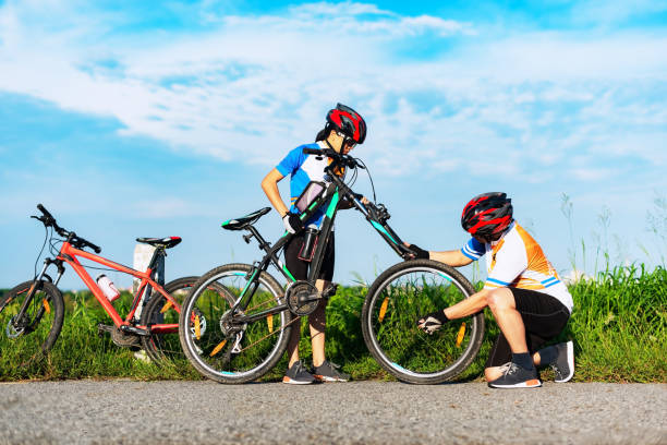 istock Two riders have problems during the road, needing tires to repair, help with problems. 1328414763