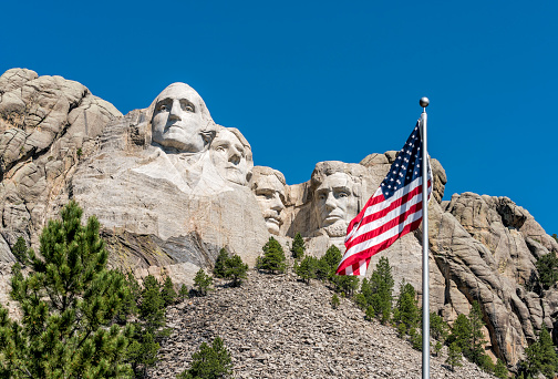American flag waiving in front of Mount Rushmore president National Sculpture, South Dakota