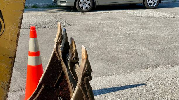 Photos excavator teeth road repair water pipe cone