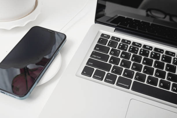 istock Charging smartphone battery with wireless charger device 1328422621