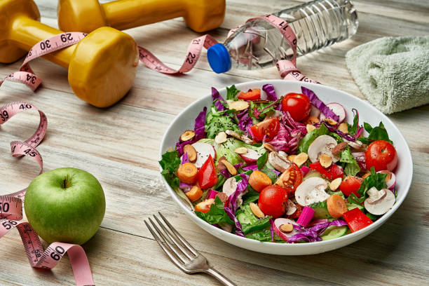 istock Healthy eating and diet concepts. Spring salad shot from above on rustic wood table 1328423717