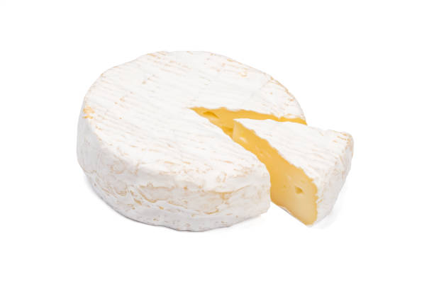 istock Camembert cheese with a cut piece isolated on a white background. 1328425532