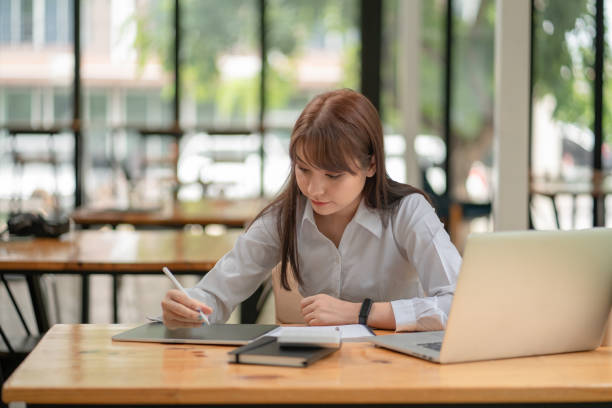 istock Business women use tablets to write work plans 1328430874