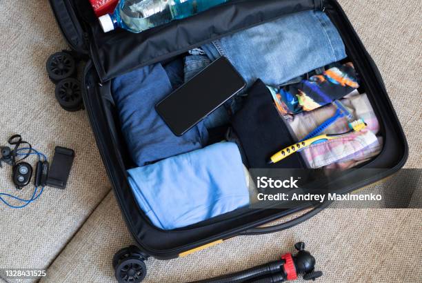 Preparing For The Trip Collecting Things Stock Photo - Download Image Now - Carry-On Luggage, Packing, Crowded