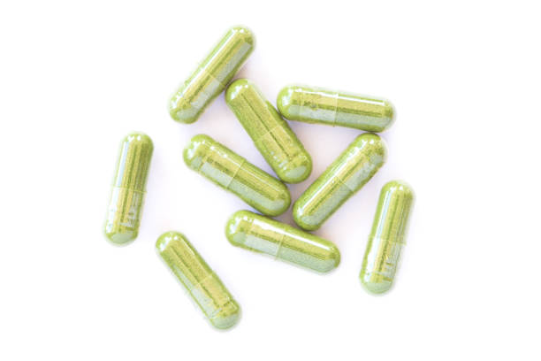 istock green herbal powder medicine capsule pill isolated on white 1328432687