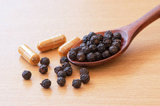 istock Black pepper and turmeric powder capsule 1328432688