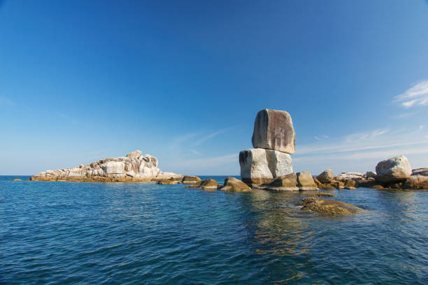 thaïlande voyage île koh lipe stonehenge pinnacle dans la mer lointaine de l’océan avec grand chevauchement de pierre et ensoleillé ciel bleu clair paysage - clear sky asia sky old ruin photos et images de collection