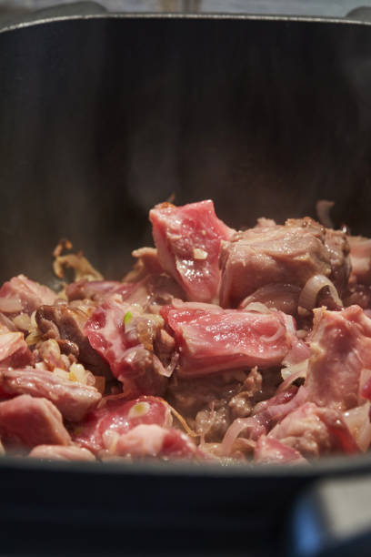 Young Lamb is fried over low heat in cauldron. Step by step recipe.