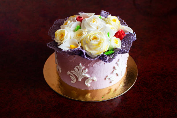 istock Beautiful birthday cake with mastic flowers decor. 1328435958