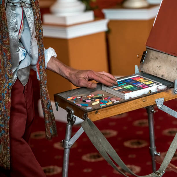 Artist's workplace. Set of dry soft multicolored square pastels and easel.