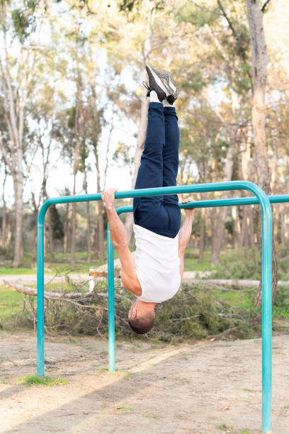istock Male athlete exercising head to the ground on parallel bars 1328442711