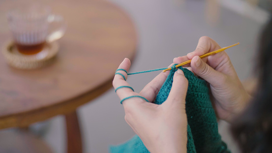 Asian Woman Crocheting at home.  ,Thailand, real time, lifestyles ,diy ,Knitting ,Hobbies ,crochet , Learning a hobby, enjoying relaxation, looking happy, lifestyle concept