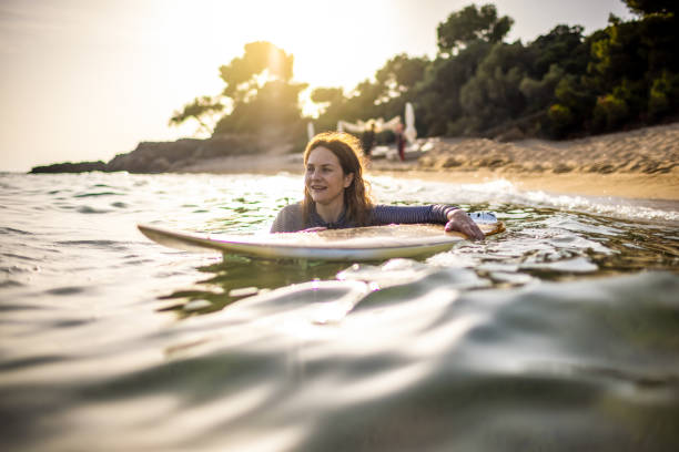istock Surfer woman at the sea 1328443052