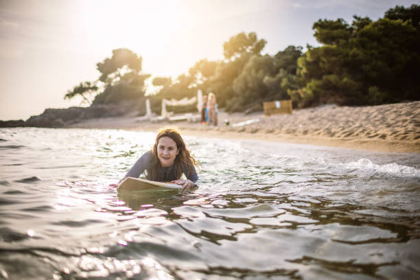 istock Surfer woman at the sea 1328443084