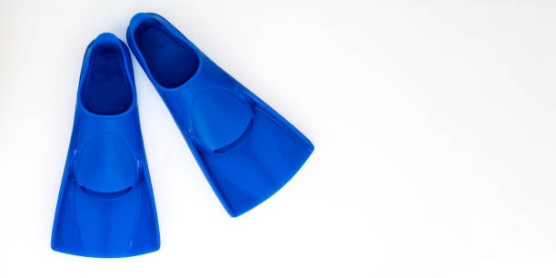istock Blue flippers on a white background. Baner Flat lay. Copy space 1328444732