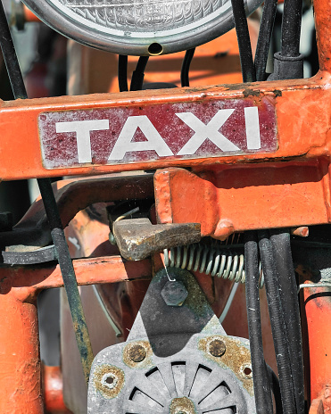Detail of a moped used as a taxi.