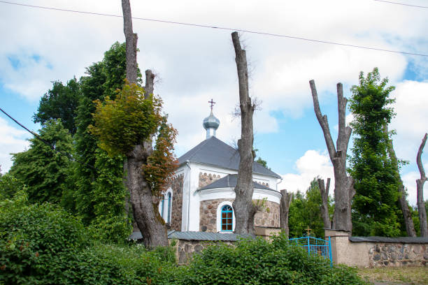 istock Old stone church among green trees closeup 1328445534