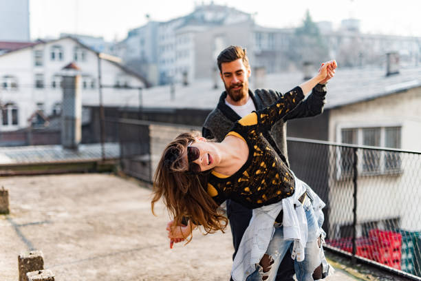 istock Carefree couple having fun on a balcony. 1328449453