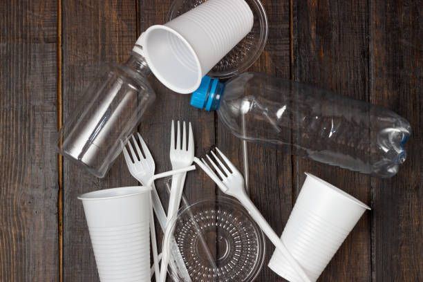 istock Plastic dishes, bottles, glasses on a white table. Planet pollution 1328449459